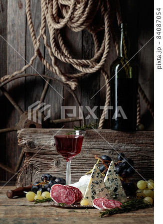 Rustic still life with wine and snacks. 84087054