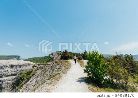 woman traveler walking on top of the mountain woman traveler walking on top of the mountain 84089170