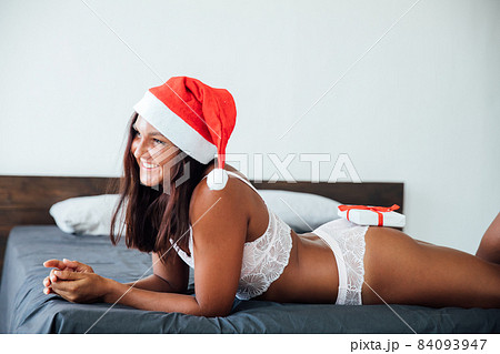 beautiful woman in lingerie for Christmas gift New Year in the bedroom 84093947