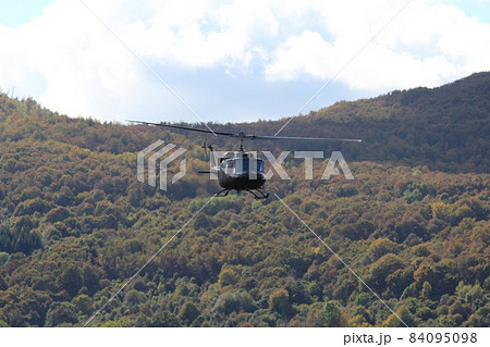The helicopter in flight over the wood The helicopter in flight over the wood 84095098