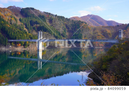 秋の徳山ダムの紅葉と徳之山八徳橋の映り込み 秋の徳山ダムの紅葉と徳之山八徳橋の映り込み 84099059