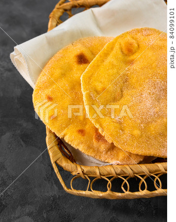 Homemade corn flatbread breadbasket gluten free meal. Handmade mexican tortilla wrapping. Traditional latin cornmeal Homemade corn flatbread breadbasket gluten free meal. Handmade mexican tortilla wrapping. Traditional latin cornmeal 84099101