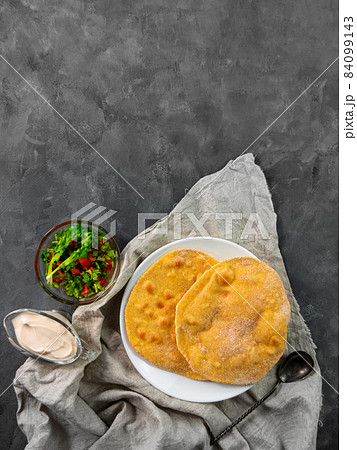 Homemade corn flatbread with cilantro green tomato salsa. Handmade mexican tortilla authentic textile Traditional Indian Homemade corn flatbread with cilantro green tomato salsa. Handmade mexican tortilla authentic textile Traditional Indian 84099143