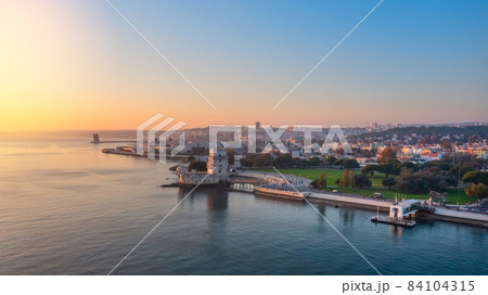Aerial view of the Portuguese Historical Folk Patrimony, Belem Tower, on the Tagus River. During sunset. 84104315
