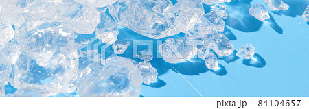 Close up crushed ice in sunlight on blue. Summer background refreshment concept 84104657