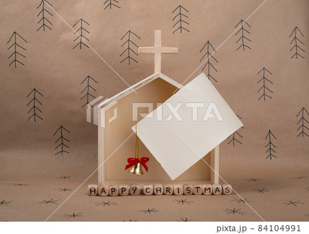 Hand made wooden Church and blank card with space for invitation or greeting. Minimal eco Christmas concept. Hand made wooden Church and blank card with space for invitation or greeting. Minimal eco Christmas concept. 84104991