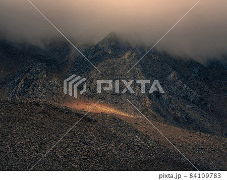 Mystical light in the misty dark mountains. Dramatic sky on moun 84109783
