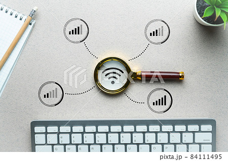 WiFi home network search concept. Magnifying glass on the table. 84111495