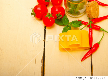 Italian pasta paccheri with tomato mint and chili pepper Italian pasta paccheri with tomato mint and chili pepper 84112273