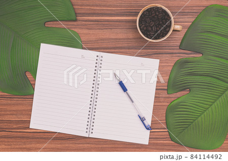 Notebook and coffee mug On the desk Notebook and coffee mug On the desk 84114492