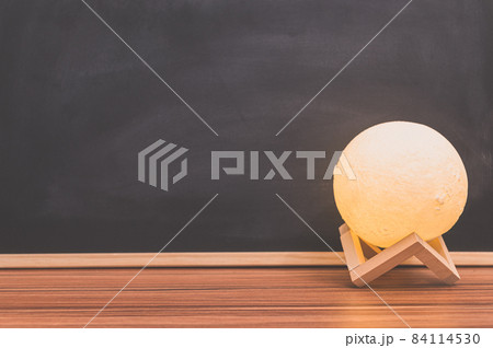 Moon shape lamp On the desk Blackboard background 84114530