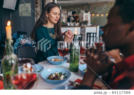 Friends Saying Prayer Before Eating Meal Together. Friends Saying Prayer Before Eating Meal Together. 84117366