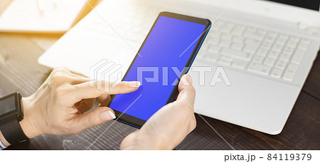 Young woman using smartphone at office Young woman using smartphone at office 84119379