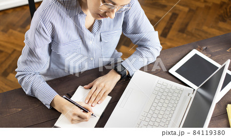 Businesswoman working with laptop at home Businesswoman working with laptop at home 84119380