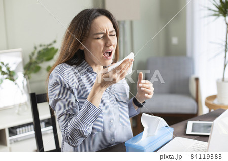 Freelancer young woman suffering from cold Freelancer young woman suffering from cold 84119383