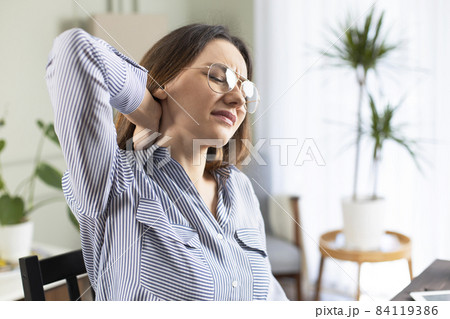 Freelancer young woman suffering with neck pain 84119386
