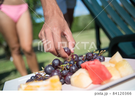 Close-up of fruits near swimming pool Close-up of fruits near swimming pool 84120366