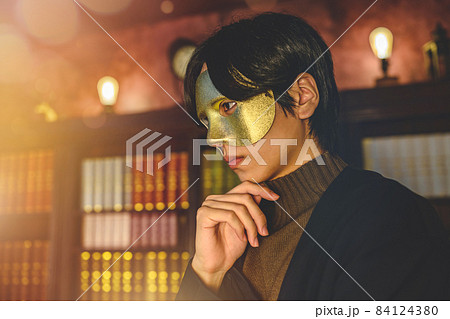 書斎で仮面を着けた男性 84124380