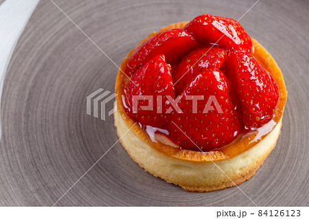 Mini tart with strawberries close up. Berry dessert Mini tart with strawberries close up. Berry dessert 84126123
