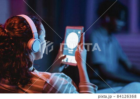 back view woman home using headphones tablet. High quality beautiful photo concept 84126368