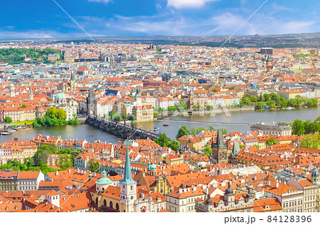 Top aerial panoramic view of Prague historical city centre with red tiled roof buildings in Mala Strana Top aerial panoramic view of Prague historical city centre with red tiled roof buildings in Mala Strana 84128396