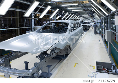 Car bodies are on assembly line. Factory for production of cars. Modern automotive industry 84128779