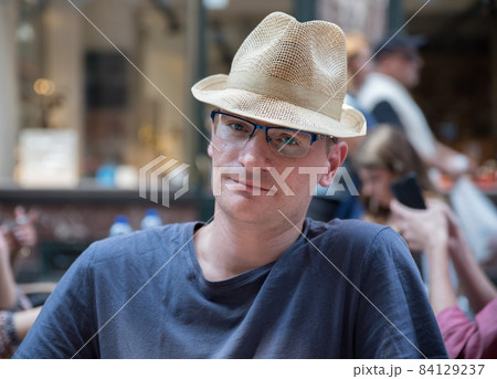 Portrait of a confident 40 year old man with a summer hat Portrait of a confident 40 year old man with a summer hat 84129237