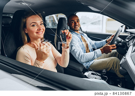 Happy excited couple buying a new car and showing keys Happy excited couple buying a new car and showing keys 84130867