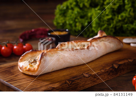 Delicious fresh street pizza with chicken, mushrooms and cheese 84131149