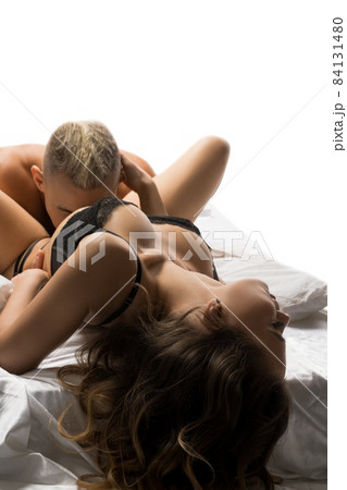 Voluptuous couple enjoying foreplay on soft bed 84131480