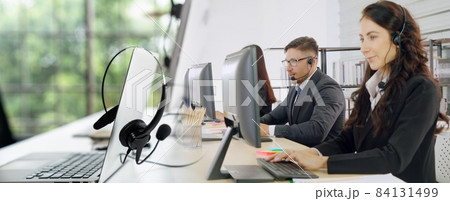 Business people wearing headset working in office broaden view Business people wearing headset working in office broaden view 84131499