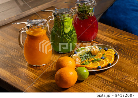 fruit and berry lemonades on the wooden tray with spruce. 84132087