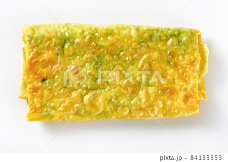 burrito with cheese and greens filings on a white burrito with cheese and greens filings on a white 84133353