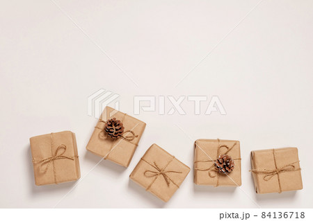 Festive background mockup for Christmas or New Year copy space. Gifts in paper eco-friendly packaging white background Festive background mockup for Christmas or New Year copy space. Gifts in paper eco-friendly packaging white background 84136718