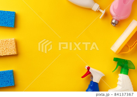 Set of cleaning supplies on yellow color background 84137367