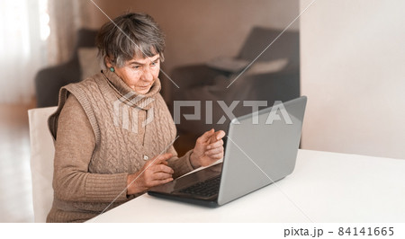 Old woman wearing casual clothes such as knitted sweater, 84141665