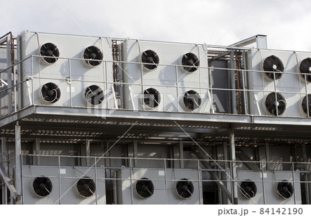 Several air conditioners on the gray wall of the factory. sunny day 84142190
