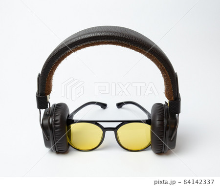 on-ear headphones and sunglasses on a white background 84142337
