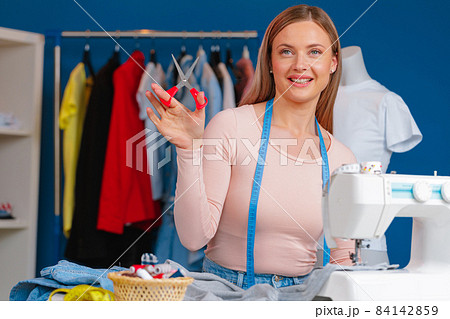 Woman seamstress working at textile factory close up 84142859