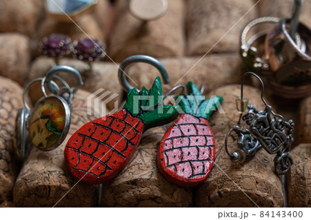 Different jewelry is stuck in a stand of wine corks 84143400