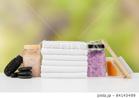 Various spa beauty threatment products and towels against blurred background Various spa beauty threatment products and towels against blurred background 84143499