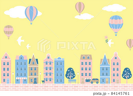 空に浮かぶ気球とカラフルな家や店が立ち並ぶ街のイラストの背景素材のイラスト素材