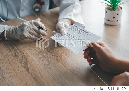 Doctors are writing in coronavirus vaccination card Doctors are writing in coronavirus vaccination card 84146109