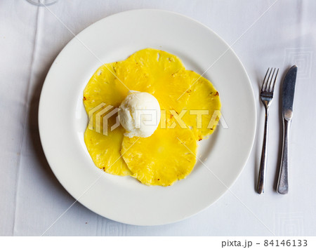 Fruit carpaccio from sweet pineapple with citrus ice cream Fruit carpaccio from sweet pineapple with citrus ice cream 84146133