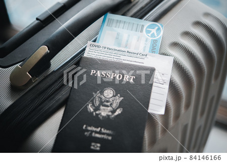 Passports and suitcases to prepare for the trip and coronavirus vaccination card, map for travel with luggage for the trip. Covid-19 around the world Passports and suitcases to prepare for the trip and coronavirus vaccination card, map for travel with luggage for the trip. Covid-19 around the world 84146166