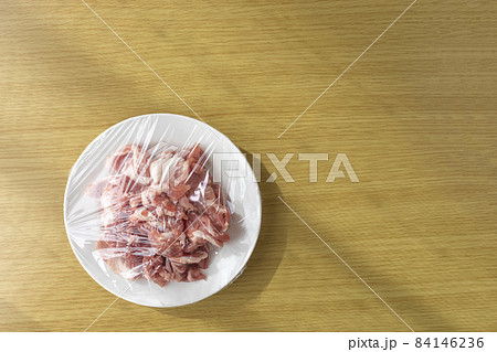 皿にのせてラップをかけた豚肉 84146236