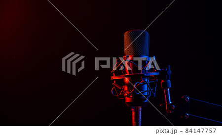 Professional microphone in pink smoke on a black background. Professional microphone in pink smoke on a black background. 84147757