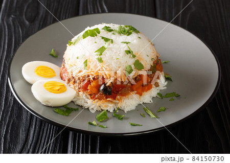 Arroz tapado is a classic Peruvian layered rice and ground beef dish close up in the plate. Horizontal 84150730