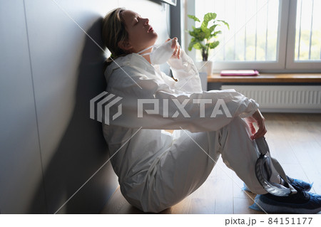A woman in a protective suit is breathing without a mask 84151177