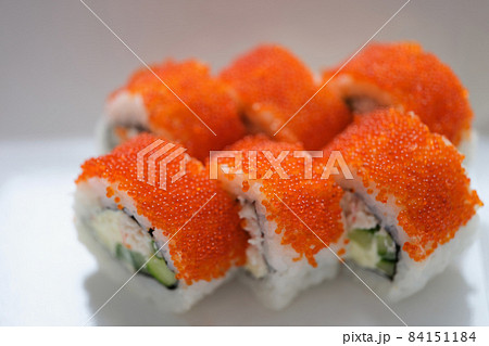 Sushi with orange flying fish caviar on a white plate 84151184
